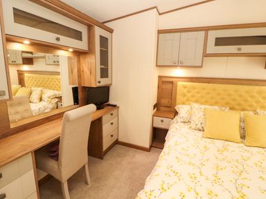 A bedroom with a bed and desk area at 22 Yealand in Carnforth