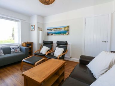 A living room with a sofa and armchairs at Swn Y Don