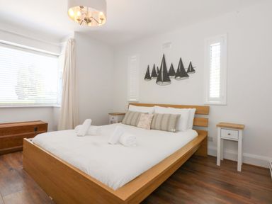 A bedroom with a bed and bedside tables at Swn Y Don