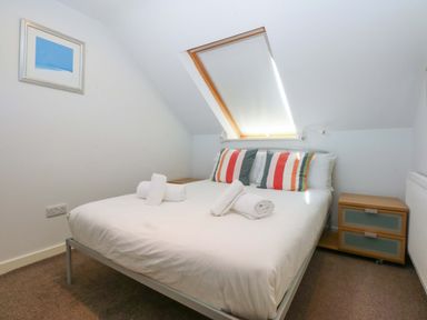 A bedroom with a bed and window at Swn Y Don 