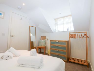 A bedroom with a bed and furniture at Swn Y Don
