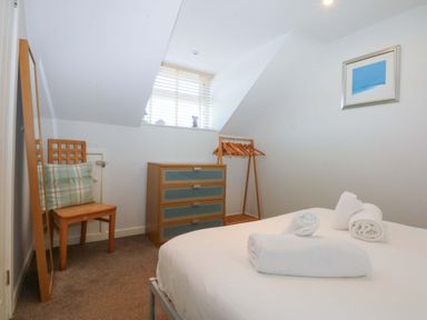 A bedroom with a bed and mirror at Swn Y Don 