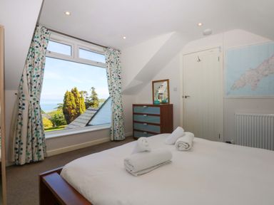A bedroom with a bed and dresser at Swn Y Don
