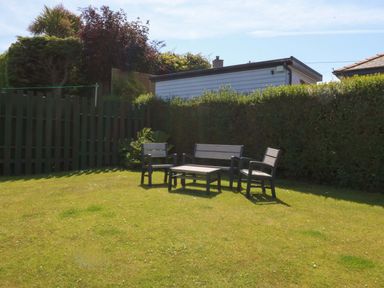 A garden with seating area and a shed at Swn Y Don