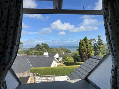 A view of the sea and houses from a window at Swn Y Don in Llanbedrog