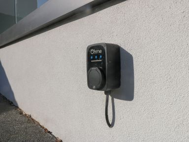 An electric vehicle charging station mounted on a wall at Swn Y Don Llanbedrog