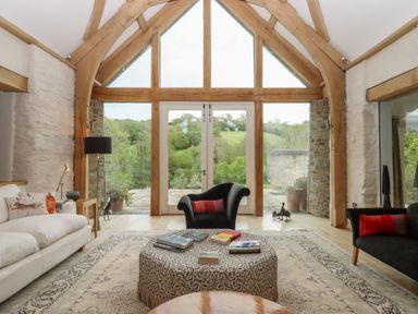 A living room with sofa and coffee table at Lower Velwell Barn in Totnes