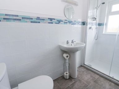 A bathroom with a sink and shower at No.1 Vanderhoof Way Saundersfoot