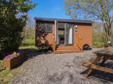A tiny house with steps and outdoor seating at Butterfly Hut 2 Forton near Garstang