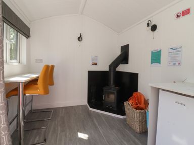 A kitchen with table and stools at Butterfly Hut 2 Forton near Garstang