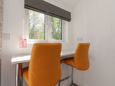 An office space with a table and two chairs at Butterfly Hut 2 Forton near Garstang