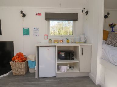 A kitchen area with fridge and microwave at Butterfly Hut 2 Forton near Garstang