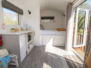 A bedroom with a kitchenette and bed at Butterfly Hut 2 Forton near Garstang
