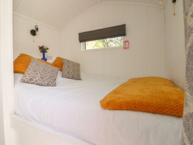 A bedroom with a bed and pillows at Butterfly Hut 2 Forton near Garstang
