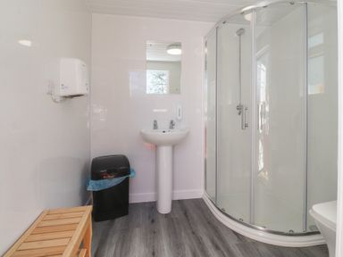 A bathroom with a shower and sink at Butterfly Hut 2 Forton near Garstang
