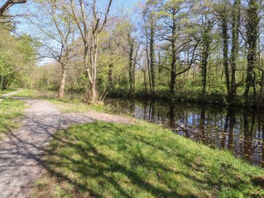 A pathway alongside a body of water in Butterfly Hut 2 Forton near Garstang