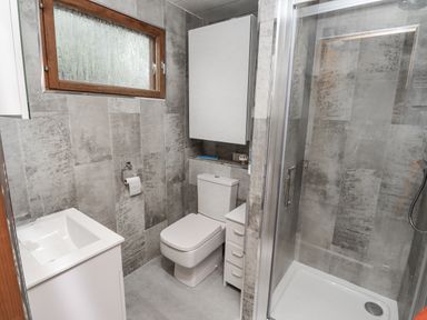 A bathroom with toilet and shower at Farnes Lodge Longframlington