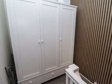 A white wardrobe in a hallway at Seahorse Cottage in Chathill