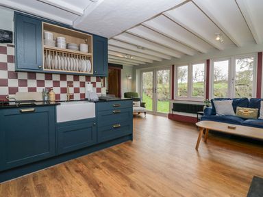 A kitchen with a sink and cupboards at Grove House in Grange-Over-Sands