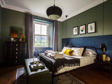 A bedroom with a bed and a dresser at Grove House in Grange-Over-Sands