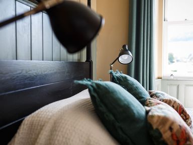 A bedroom with a bed and bedside lamps at Grove House in Grange-Over-Sands