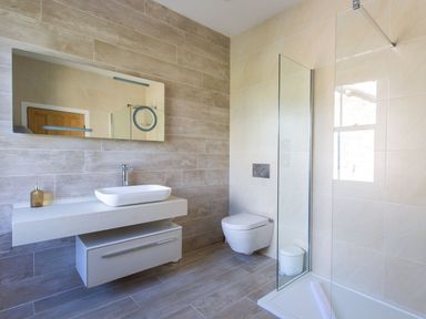 A bathroom with a washbasin and mirror at Grove House in Grange-Over-Sands