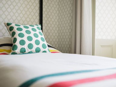 A bed with a pillow in a bedroom at Grove House in Grange-Over-Sands