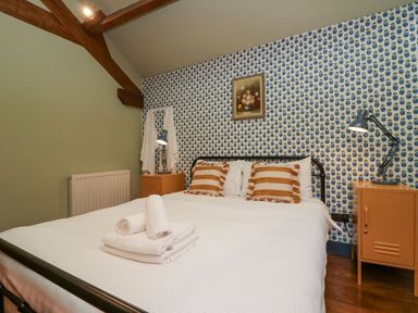 A bedroom with a bed and bedside table at Grove House in Grange-Over-Sands