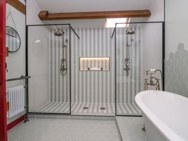 A bathroom with a shower and bathtub at Grove House in Grange-Over-Sands