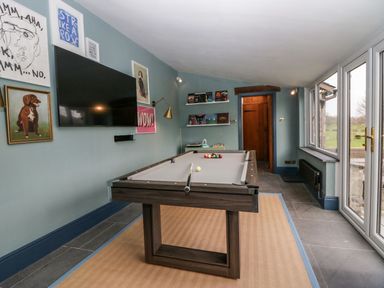 A games room with a pool table and television at Grove House in Grange-Over-Sands