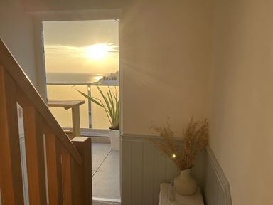 A staircase leading to an ocean view at Still Waters in Brixham
