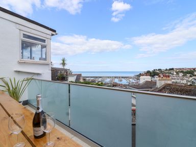 A balcony with a view of the sea and marina at Still Waters in Brixham