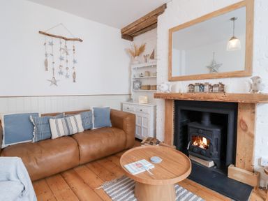 A living room with a sofa and coffee table at Still Waters in Brixham