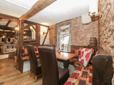 A dining room with a table and chairs at Penny Farthing Inn in Aston Crews near Ross-On-Wye