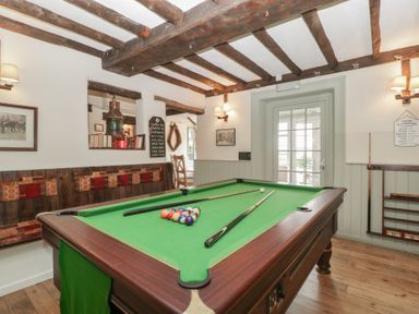 A games room with a pool table and bench seating at Penny Farthing Inn Aston Crews near Ross-On-Wye