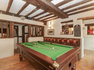 A snug room with a pool table and framed pictures at Penny Farthing Inn Aston Crews near Ross-On-Wye