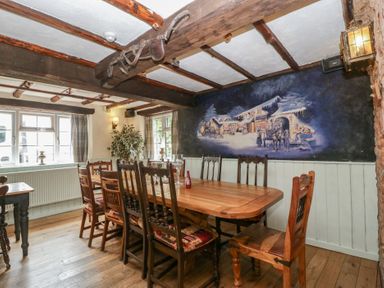 A dining room with a large table and chairs at Penny Farthing Inn Aston Crews near Ross-On-Wye