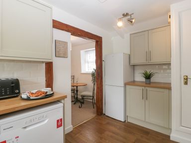 A kitchen with appliances including a dishwasher and refrigerator at Penny Farthing Inn Aston Crews near Ross-On-Wye