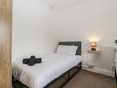 A bedroom with a bed and a nightstand at Penny Farthing Inn Aston Crews near Ross-On-Wye