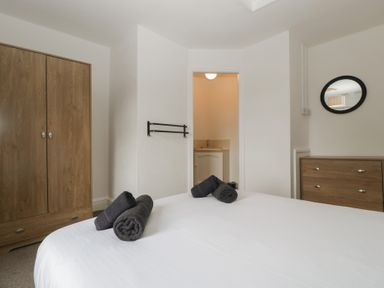 A bedroom with a bed and wardrobe at Penny Farthing Inn Aston Crews near Ross-On-Wye