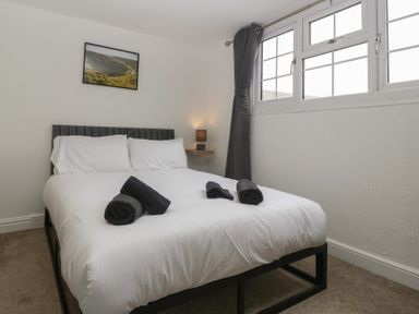 A bedroom with a bed and towels on top at Penny Farthing Inn Aston Crews near Ross-On-Wye