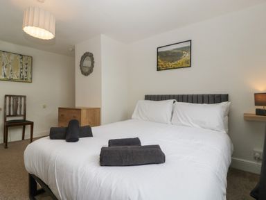 A bedroom with a bed and wall art at Penny Farthing Inn Aston Crews near Ross-On-Wye
