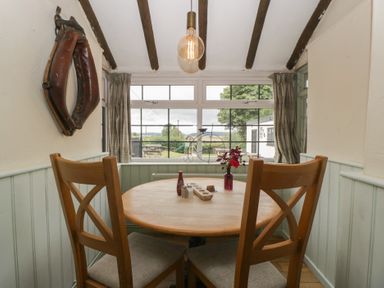 A dining room with a round table and chairs at Penny Farthing Inn Aston Crews near Ross-On-Wye