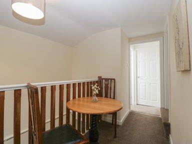 A hallway with a table and chair at Penny Farthing Inn, Aston Crews near Ross-On-Wye