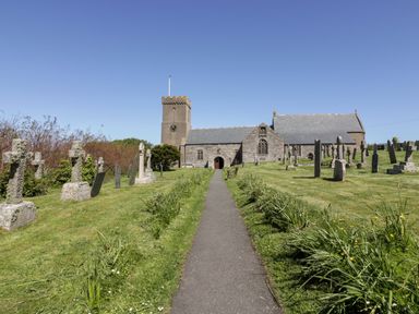 A church with a path and graves at Byron’s Retreat in Crantock