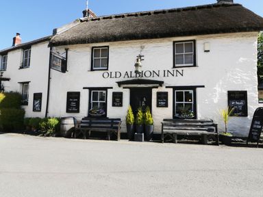 An exterior view of a building with signage at Old Albion Inn in Crantock