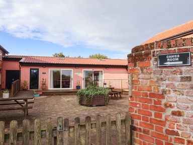 A games room with outdoor seating at Hayloft in Ipswich