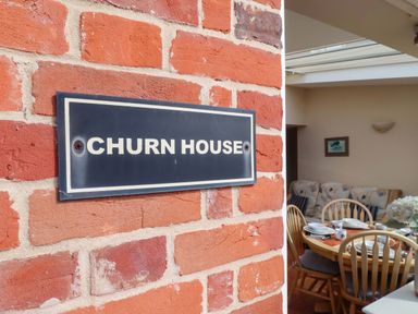 A house sign on a brick wall at Churn House in Ipswich
