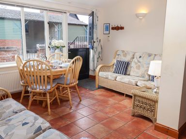 A dining room with a table and chairs at Churn House in Ipswich