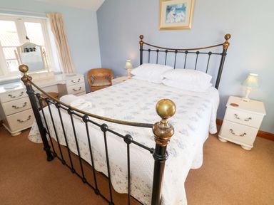 A bedroom with a bed and bedside tables at Churn House in Ipswich